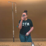 Image of Brooklyn hooked up to an IV in a t-shirt and leggings